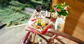 Enjoy red wine, cheese and grapes sat outside Fairfield Shepherd's hut at Acorn Farm in Devon 