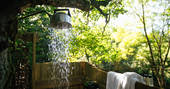 Shower amongst the trees at Turners Woodland Suite at Acorn Farm in Devon