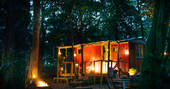 The burnt orange shepherd's hut at Turner's Woodland Suite, which houses a fully-equipped kitchen