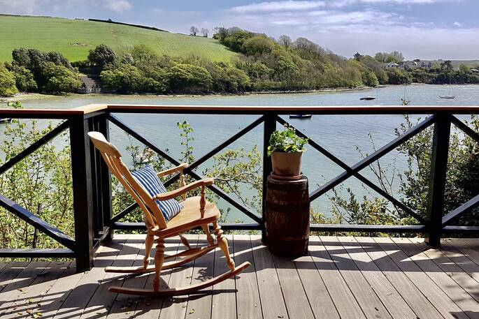 Sit and sip on the balcony overlooking the water from Bowcombe Boathouse in Devon 