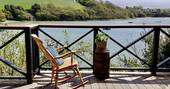 Sit and sip on the balcony overlooking the water from Bowcombe Boathouse in Devon 