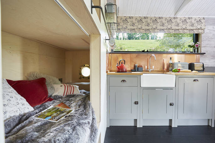 Kids will love wildlife spotting from Brownscombe Cabin's children's bunk beds through the porthole windows