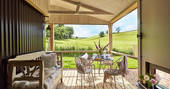 Sit on Brownscombe Cabin's covered outside deck to have breakfast with countryside views across the neighbouring barley fields