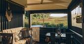 Sit on Brownscombe Cabin's covered outside deck to have breakfast with countryside views across the neighbouring barley fields