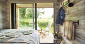 Views from the cabin's double bed of green fields at Brownscombe Luxury Glamping