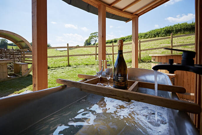 Covered deck area with a bath tub