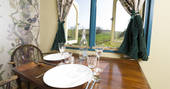 The dining table inside Brownscombe Tabernacle with views of Devon countryside 