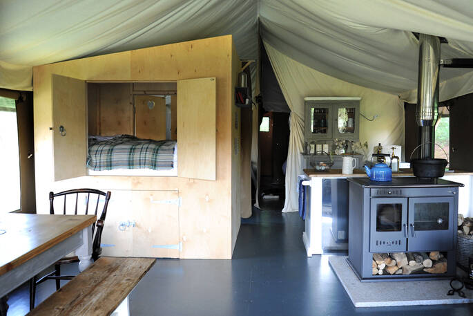 Bovey safari tent for six interior space within living area, woodburner and double cabin bed