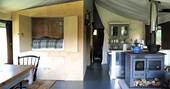 Bovey safari tent for six interior space within living area, woodburner and double cabin bed