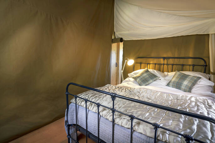 Comfy king-size bed in Dart safari tent in Devon