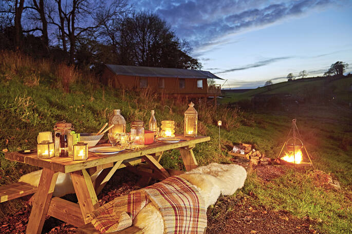 Gather together for a camp fire meal around the picnic table as stars fill the night sky