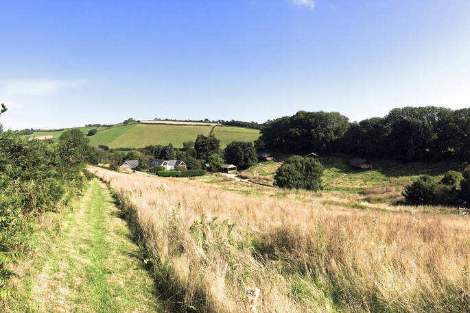 Rolling Devon countryside and view out across Brownscombe Luxury Glamping and safari tents