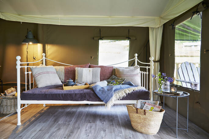 The day bed - a perfect place to relax in Dart safari tent, Devon