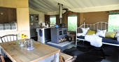 Brownscombe safari tent for six interior living space, kitchen and double cabin bed