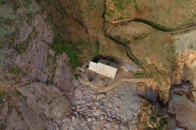 Aerial view of the beach hut showing the steep path down