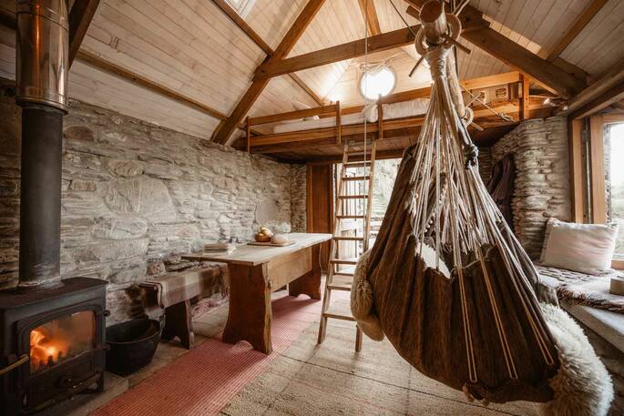 Interior showing dining area, wood burner and swing