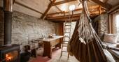 Interior showing dining area, wood burner and swing