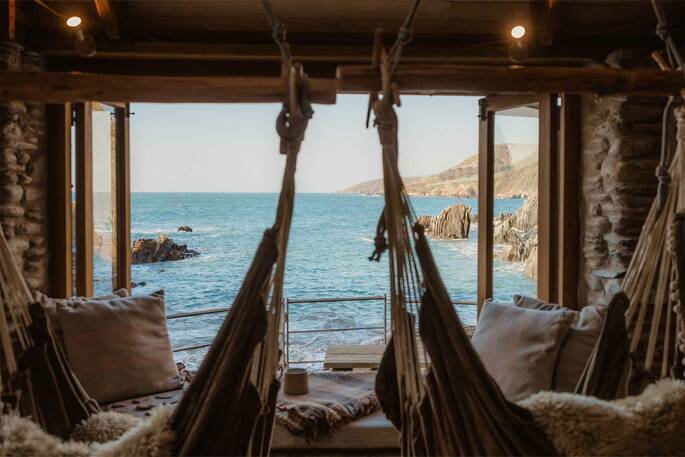 Relaxing swinging hammocks in in the living area with a view to the sea