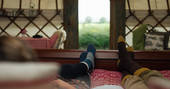 Guests of Great links lying down on the comfortable double bed looking out into the countryside 