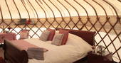 Relax in the comfortable double bed inside Great Links at Devon Yurt