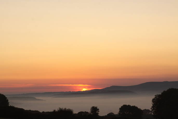 Beautiful sunrise over the Devon countryside near Great Links Yurt