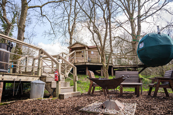 The Pheasant's Retreat treehouse outdoor firepit and BBQ area, Crediton, Devon, England