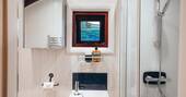 Bathroom with a hot shower, sink and flushing toilet