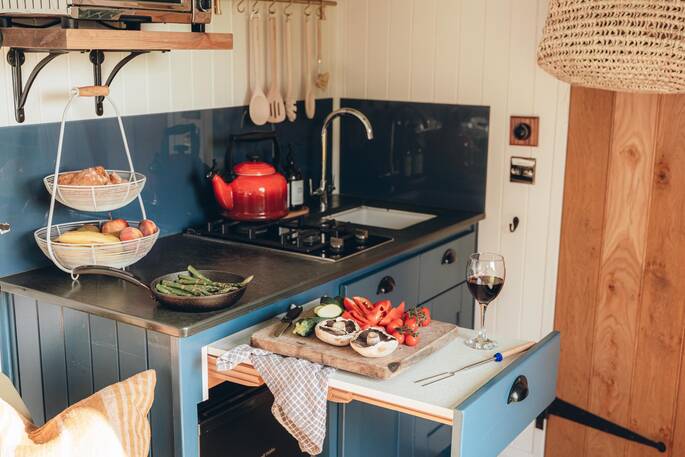 Kitchen equipped with a two ring hob, oven and cooking utensils