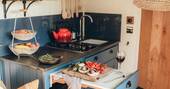 Kitchen equipped with a two ring hob, oven and cooking utensils