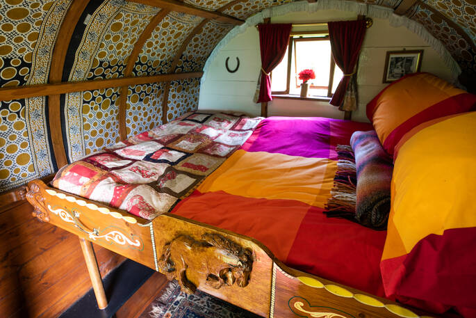 A colourful bed-spread in one of the Vintage Vardos wagons in Devon
