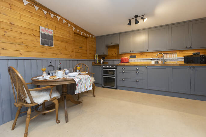 Kitchen equipped with an oven, hob, kettle, toaster and cooking utensils