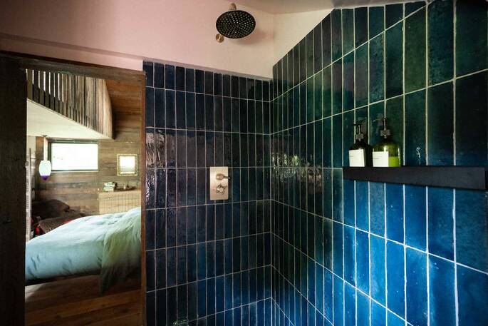 Bathroom with a hot shower, sink and flushing toilet