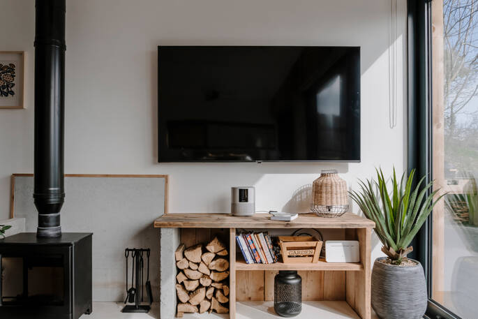 Living area with a smart TV and a wood burner
