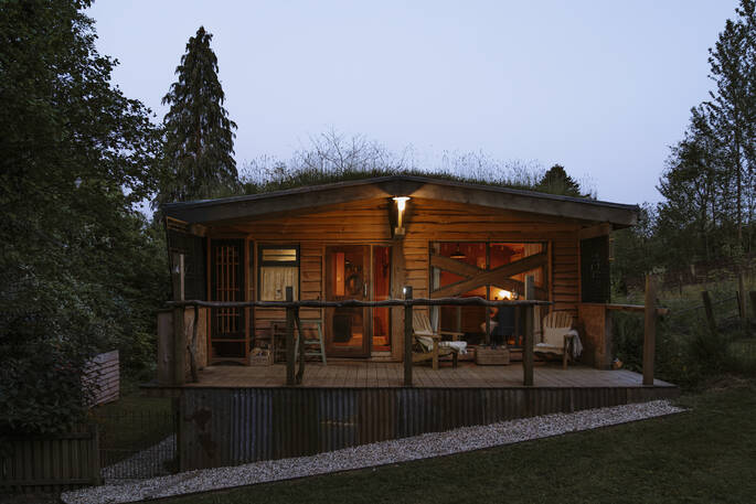 Hill's Cross Hide cabin at night, Honiton, Devon, England