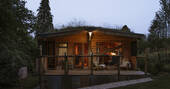 Hill's Cross Hide cabin at night, Honiton, Devon, England
