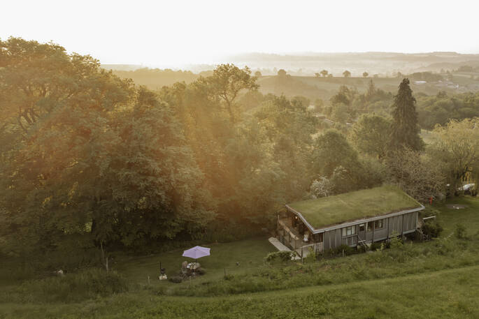 Hill's Cross Hide cabin drone view of grass roof, Honiton, Devon, England