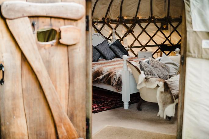 moonbeam yurt glamping holidays getaways okehampton devon england uk cosy view of bedroom through rustic wooden door