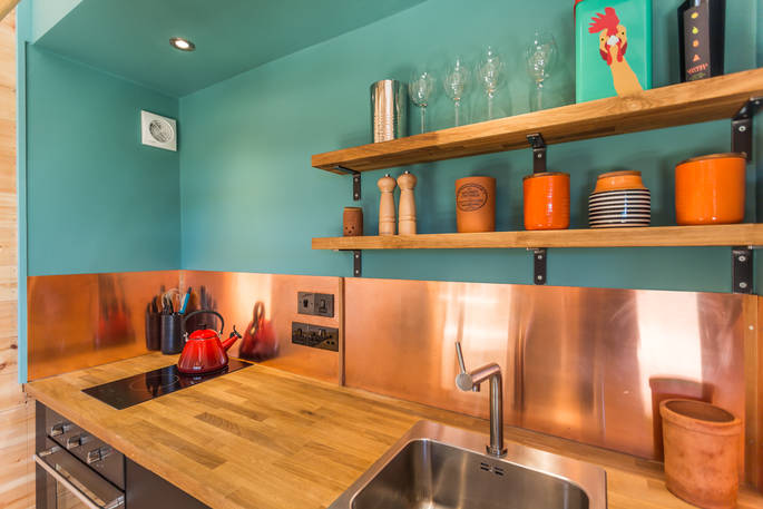 Colourful kitchen inside of The Nap cabin with cooking equipment and utensils 