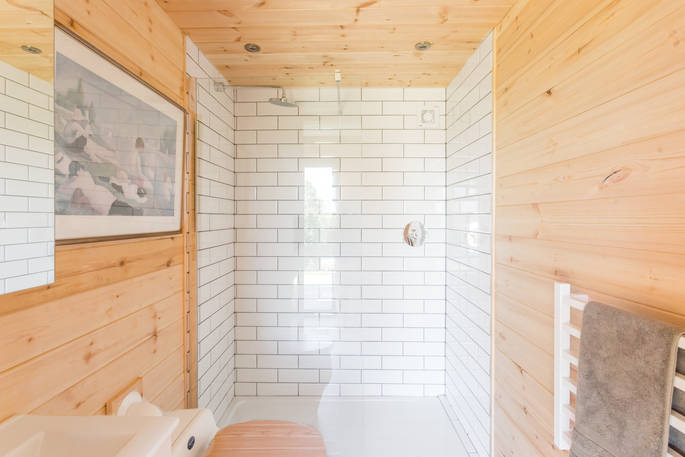 White tiled shower and bathroom in The Nap cabin