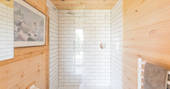 White tiled shower and bathroom in The Nap cabin