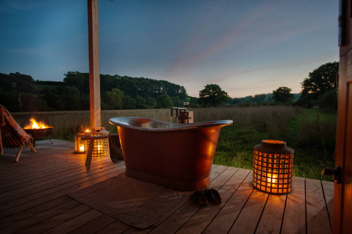 Holly Water Cabin bath tub during the night, Crediton, Devon