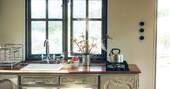 11 - Kitchen equipped with a double gas stove, sink and undercounter fridge