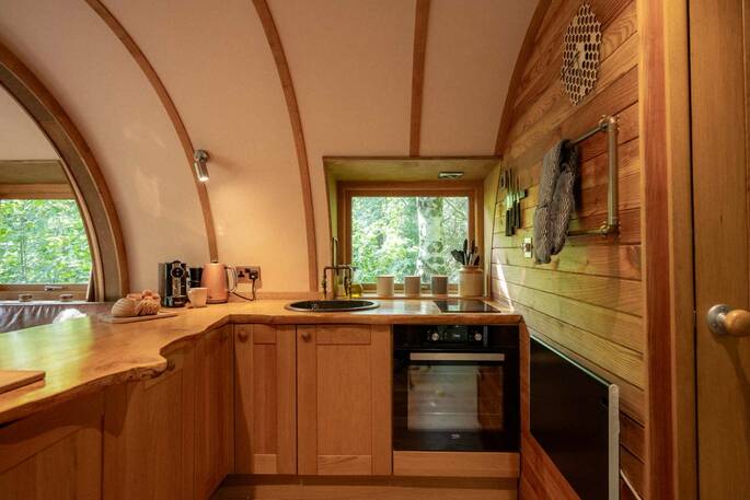 Kitchen equipped with an oven, hob, kettle and cooking utensils