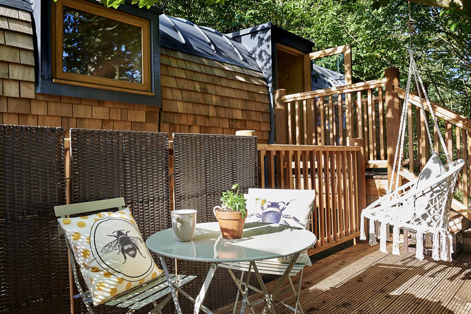 Seating area on the deck at Hideaway Treehouse at Pickwell Manor in Devon