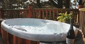 Enjoy a hot tub with bubbles at Loft Treehouse, Pickwell Manor, Devon