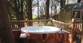 Soak in the hot tub on the deck at Loft Treehouse, Pickwell Manor, Devon