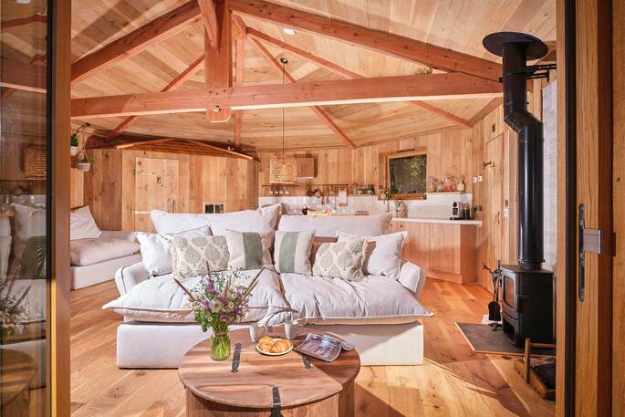 Nest Treehouse interior with wood burner, Hartland, Devon