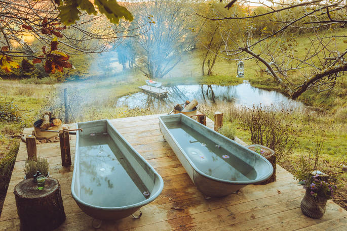 The outdoor bath tubs with view to the pond at Southcombe Piggery bothy, Dartmoor, Devon