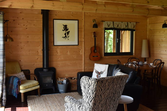 Stibb Hollow Cabin living room with wood burner, Torrington, Devon