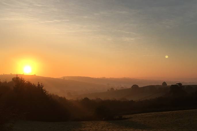 A sunset over the hills at Fleur's Retreat in Devon